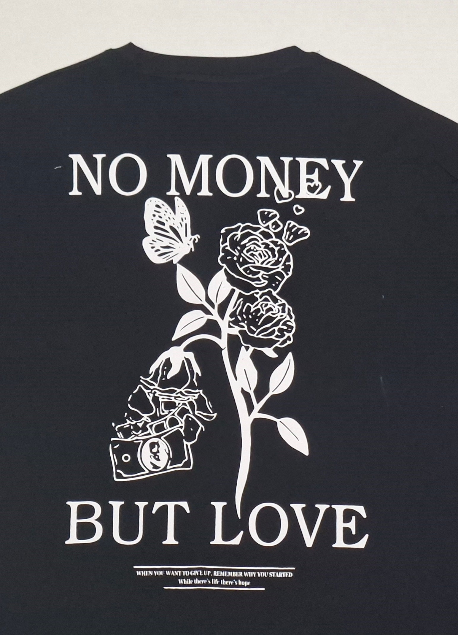 Men's Black oversized T-shirt featuring a "No Money But Love" floral and butterfly graphic print on the back.