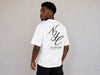 Men's white oversized T-shirt featuring a large NYC script graphic with "City of Endless Energy" text printed on the back.