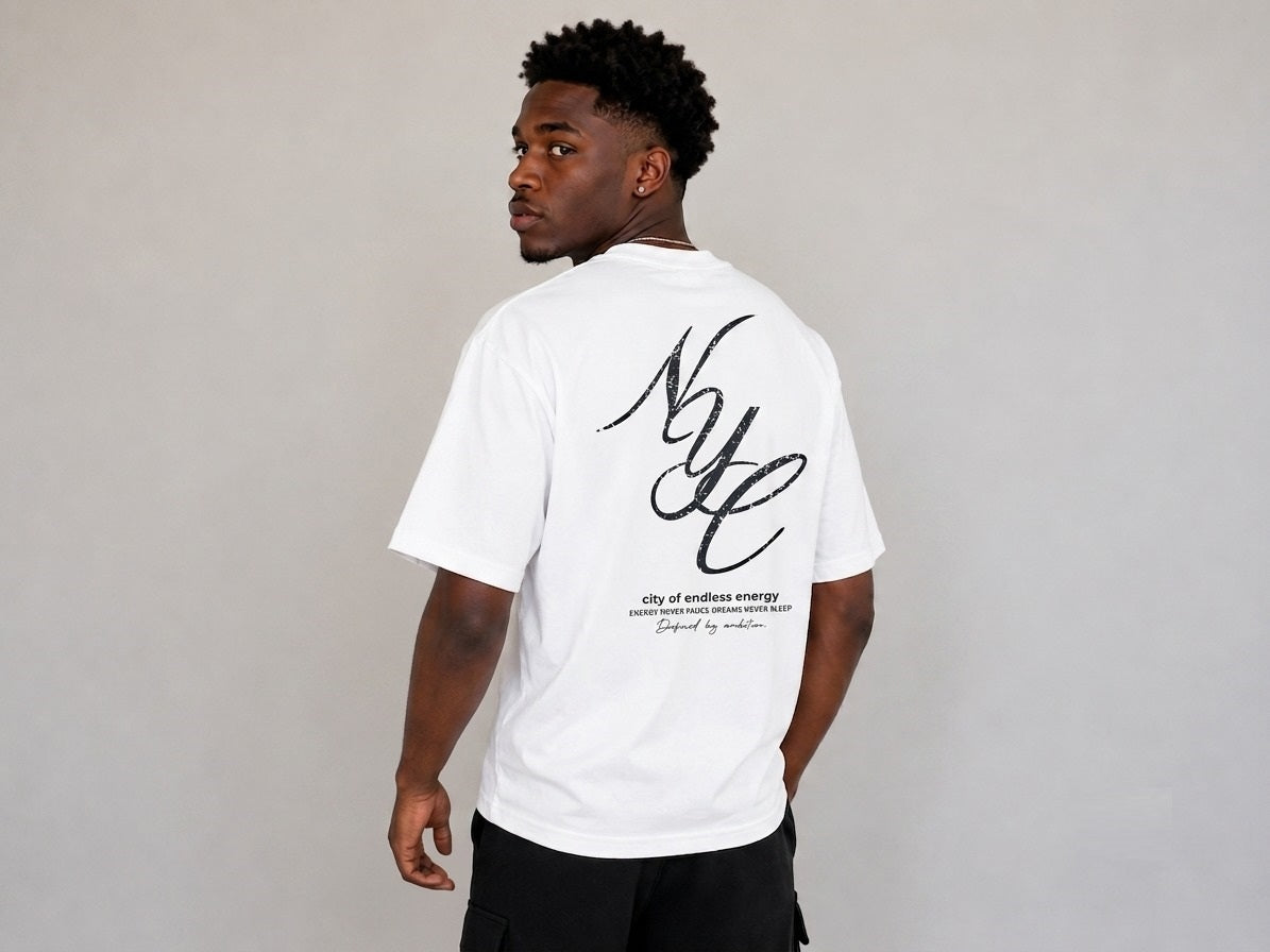 Men's white oversized T-shirt featuring a large NYC script graphic with "City of Endless Energy" text printed on the back.