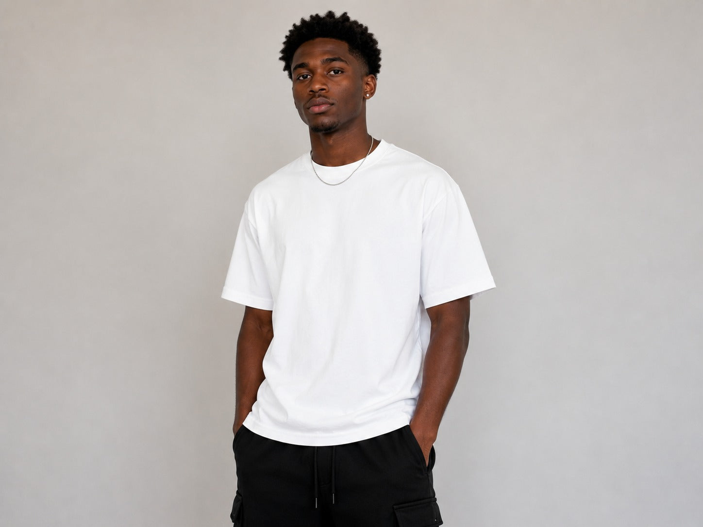 Men's white oversized T-shirt featuring a large NYC script graphic with "City of Endless Energy" text printed on the back.