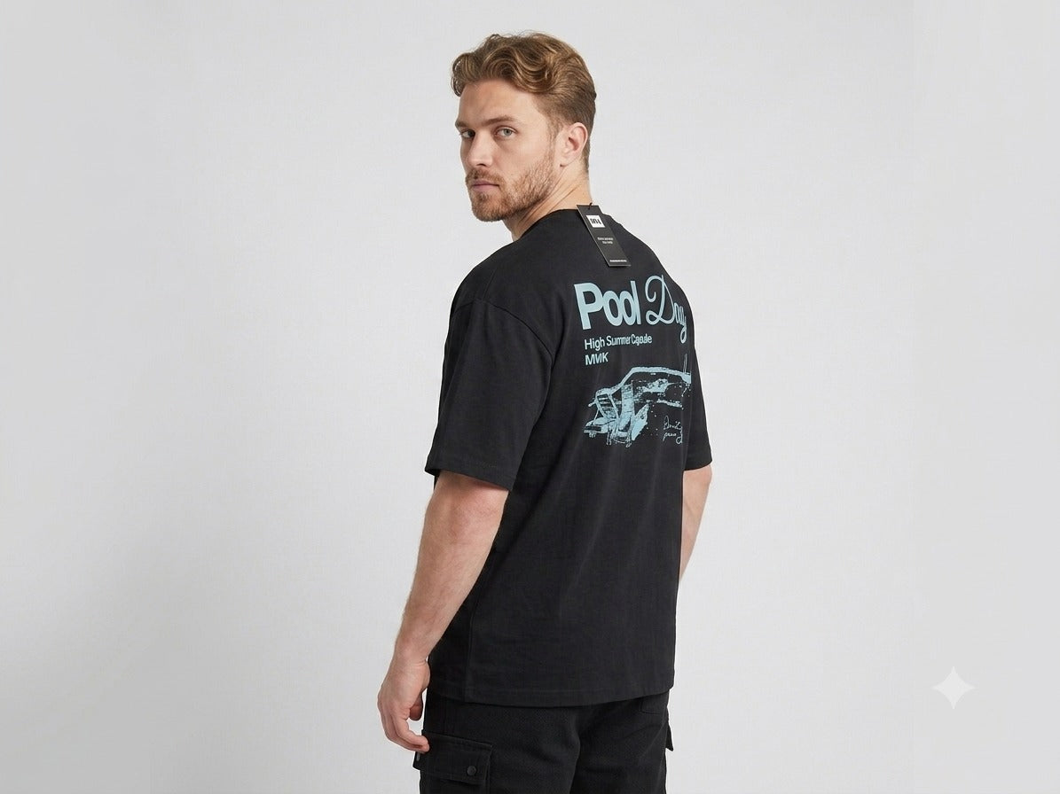 Men's black oversized T-shirt with a retro "Pool Day" graphic and poolside illustration printed on the back. uk